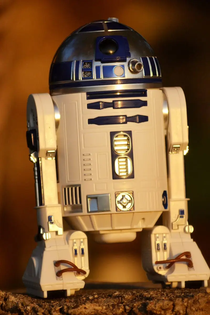 Close-up of a futuristic robot toy outdoors, showcasing its metallic and plastic components.